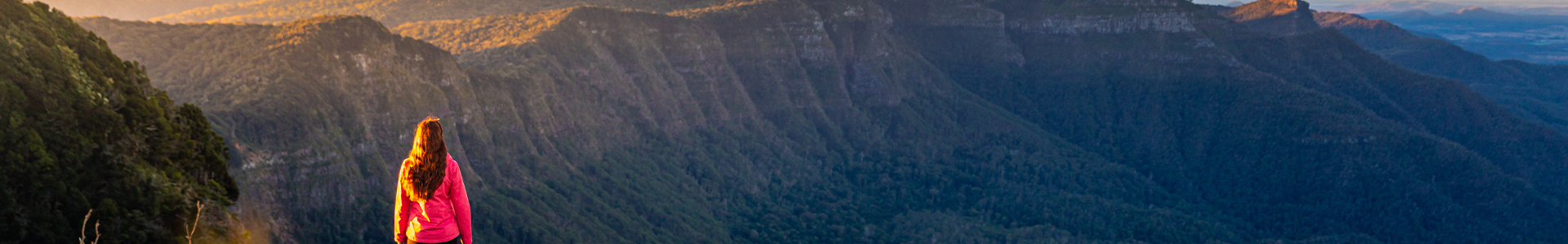 A woman looks over mountains