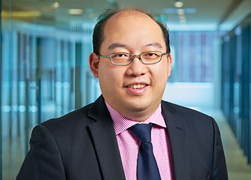 Hung Tran smiling at the camera.
