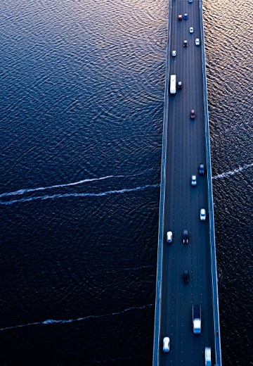 Aerial of Tasman bridge over wide flowing Derwent river in Tasmania Australia at sunset.