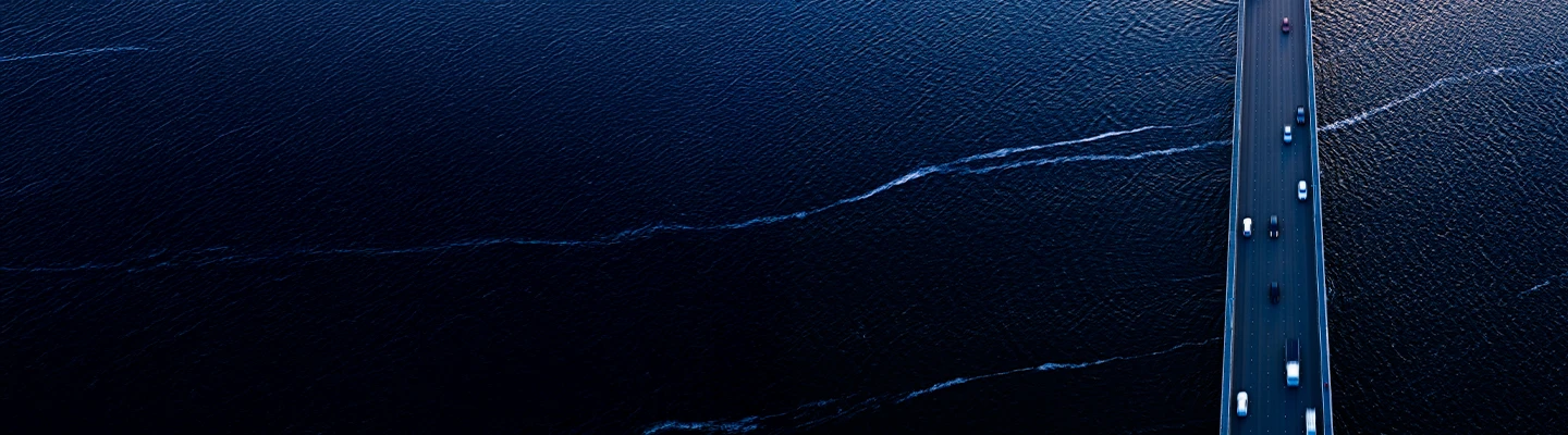 Aerial of Tasman bridge over wide flowing Derwent river in Tasmania Australia at sunset.