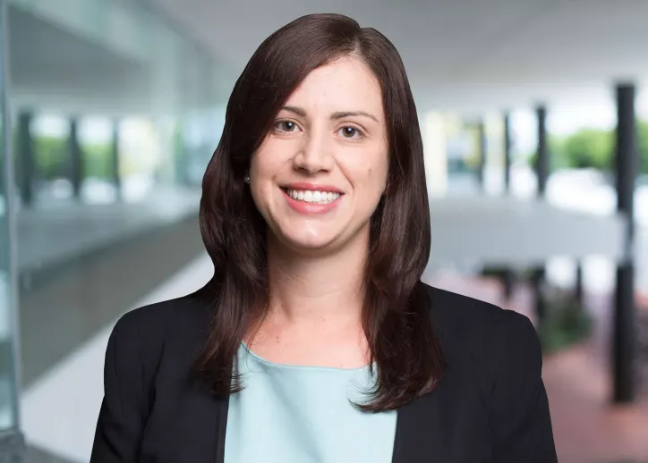 Ann Stratikopoulos smiles at the camera, with a view of BDO Cairns in the background