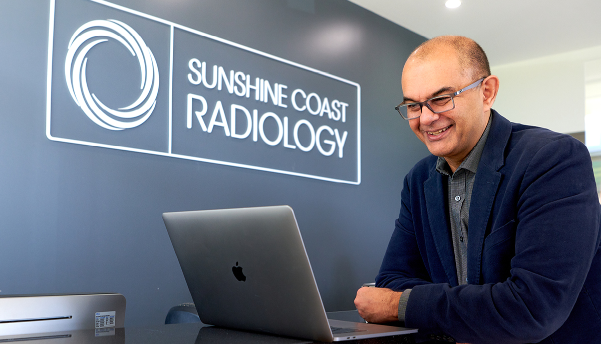 Dr Siavash Es’haghi from Imaging Queensland reads from a computer screen