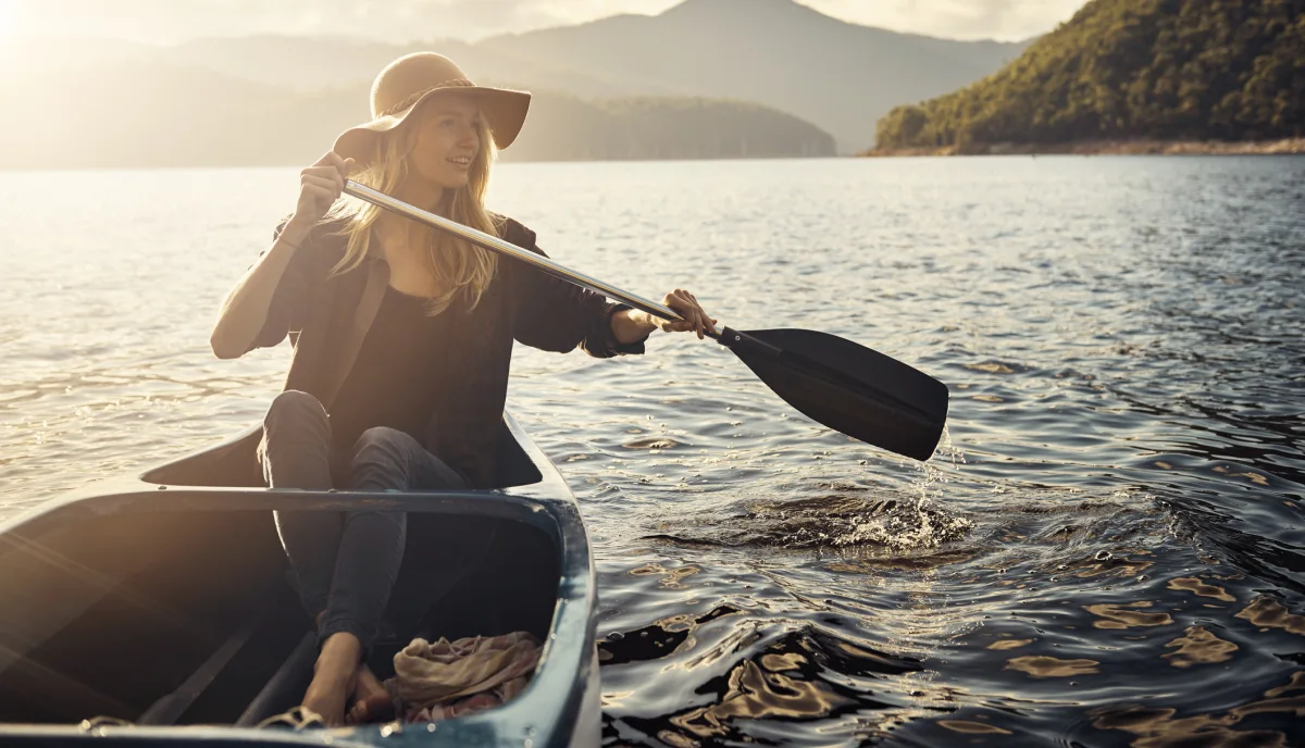 Photo of person rowing on a lake.