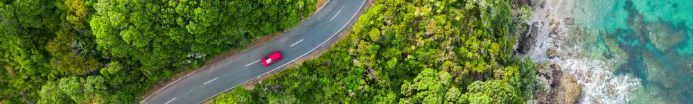 Photo of car driving through landscape.